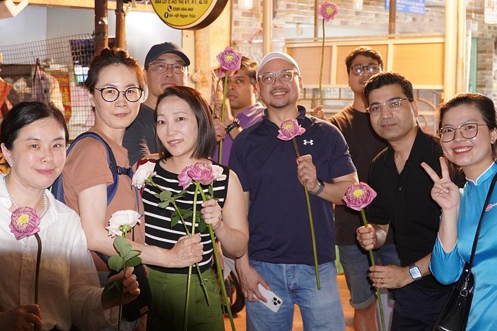 Experience Ho Chi Minh City's vibrant nightlife on a motorbike tour with a female guide, tasting local snacks and seeing city lights, photo 13 | wizardtrip