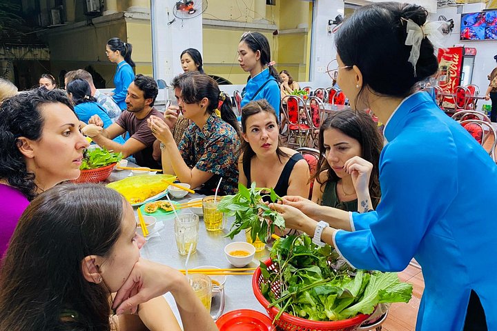 Experience Ho Chi Minh City's vibrant nightlife on a motorbike tour with a female guide, tasting local snacks and seeing city lights, photo 21 | wizardtrip