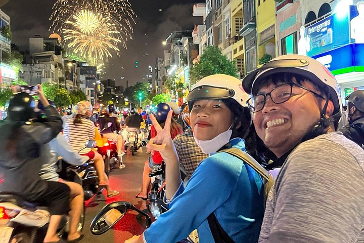 Experience Ho Chi Minh City's vibrant nightlife on a motorbike tour with a female guide, tasting local snacks and seeing city lights, photo 24 | wizardtrip