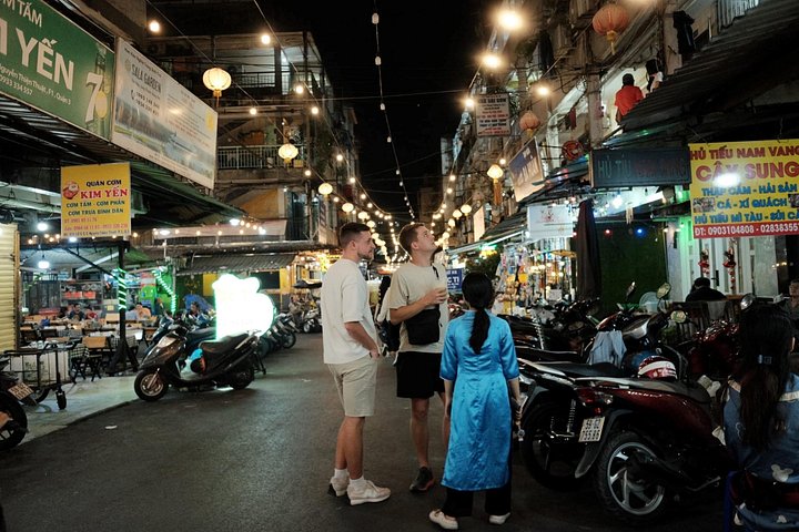 Experience Ho Chi Minh City's vibrant nightlife on a motorbike tour with a female guide, tasting local snacks and seeing city lights, photo 25 | wizardtrip