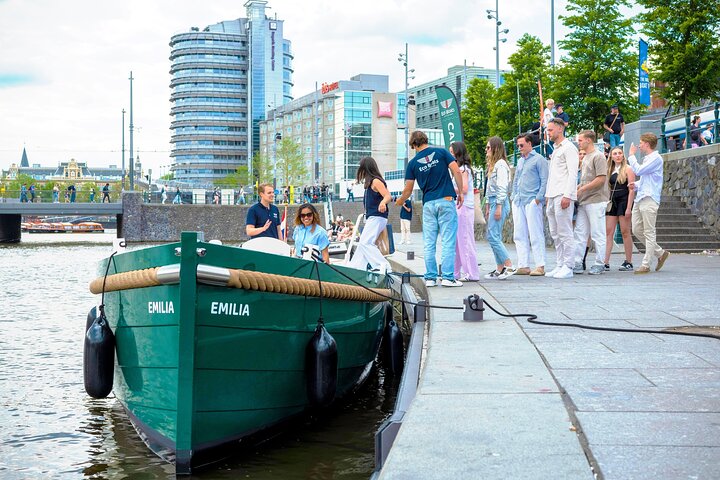Enjoy a scenic canal cruise in Amsterdam aboard a modern electric boat, passing by historic landmarks, photo 1 | wizardtrip