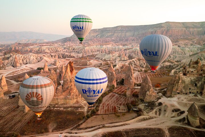 Hot air balloon floating over Cappadocia's unique rock formations at sunrise, photo 1 | wizardtrip
