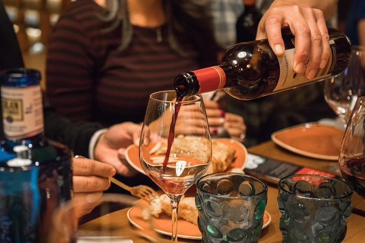 En liten grupp njuter av tapas och vin på en traditionell bar i Madrids historiska centrum, foto 14 | wizardtrip