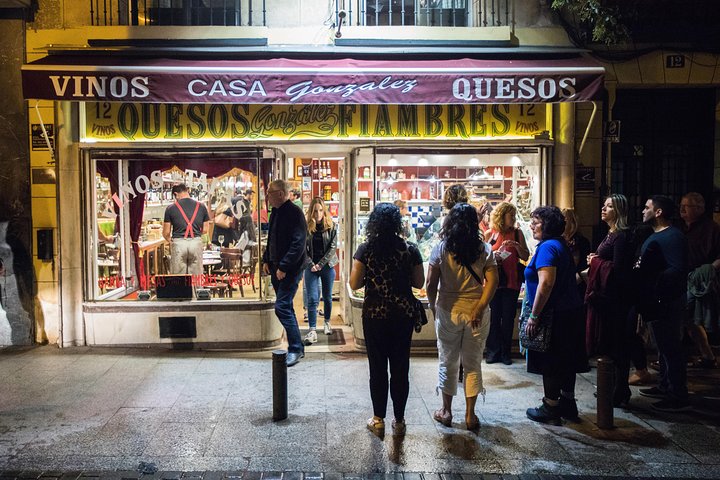 En liten grupp njuter av tapas och vin på en traditionell bar i Madrids historiska centrum, foto 16 | wizardtrip