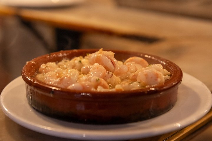 En liten grupp njuter av tapas och vin på en traditionell bar i Madrids historiska centrum, foto 23 | wizardtrip