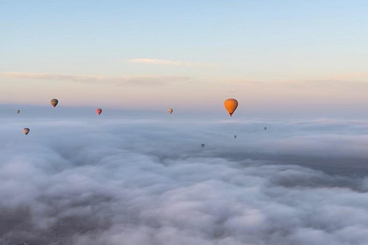 Hot air balloon floating over Marrakech at sunrise with Atlas Mountains view, photo 14 | wizardtrip
