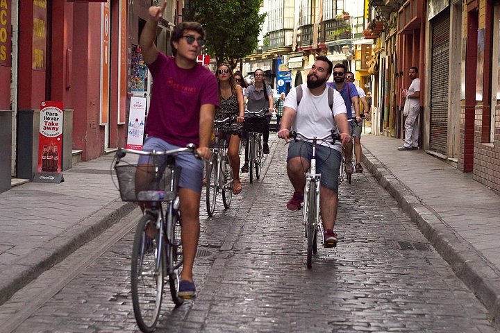 Guided bike tour exploring Seville's historic landmarks and charming neighborhoods, photo 10 | wizardtrip