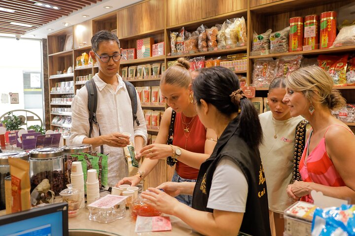 A small group enjoys a culinary tour of Hong Kong Island, tasting local foods and exploring vibrant neighborhoods, photo 7 | wizardtrip