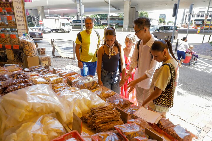 A small group enjoys a culinary tour of Hong Kong Island, tasting local foods and exploring vibrant neighborhoods, photo 10 | wizardtrip