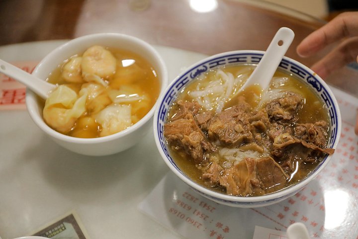 A small group enjoys a culinary tour of Hong Kong Island, tasting local foods and exploring vibrant neighborhoods, photo 13 | wizardtrip