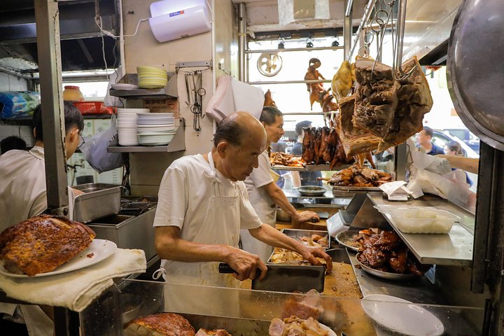 A small group enjoys a culinary tour of Hong Kong Island, tasting local foods and exploring vibrant neighborhoods, photo 15 | wizardtrip