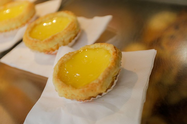 A small group enjoys a culinary tour of Hong Kong Island, tasting local foods and exploring vibrant neighborhoods, photo 17 | wizardtrip